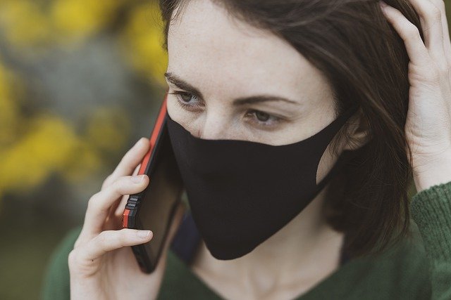 Girl wearing face mask and talking on her phone